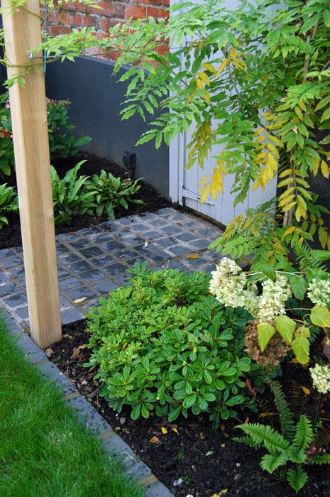 Small pergola over entrance to a fake door